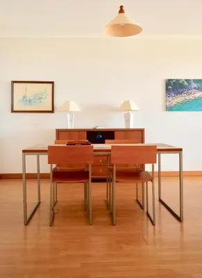 a dining room with a table and two chairs at Jardim do Arco 