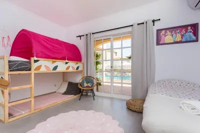 a bedroom with a bunk bed and a pool at Quinta da Liberdade in Luz