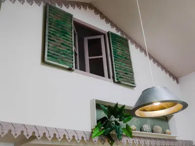 a window with green shutters and a pendant light at Casas Serenas in Estreito da Calheta