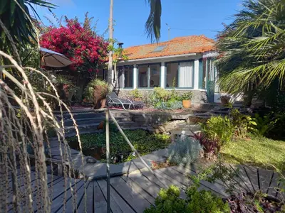 a house with a garden in front of it at Casas Serenas in Estreito da Calheta