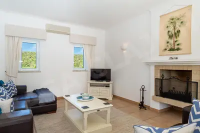 a living room with a couch and a fireplace at Casa Clajon in Budens