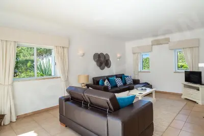 a living room with a couch and a tv at Casa Clajon in Budens