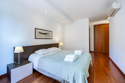 a bedroom with a bed with towels on it at Luz Beach Luxury Apartment in Luz