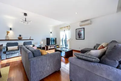a living room with two couches and a table at Luz Beach Luxury Apartment in Luz