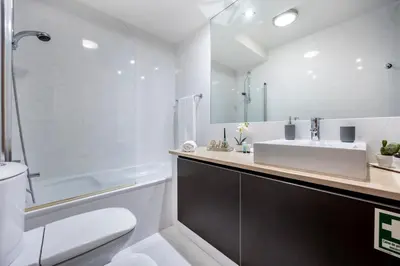 a bathroom with a sink and a toilet and a tub at Luz Beach Luxury Apartment in Luz