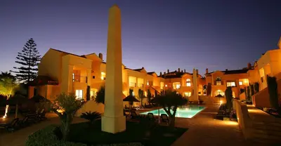 a building with a monument in the middle of a courtyard at Luz Beach Luxury Apartment in Luz