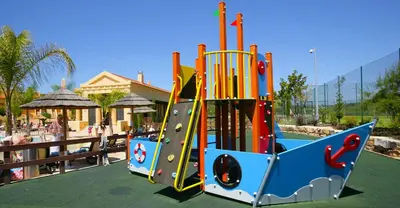 a playground with a slide in a park at Luz Beach Luxury Apartment in Luz