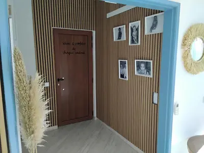a hallway with a door with pictures on the wall at AMAZING PENTHOUSE- panoramic sea view & tikki bar on private terrasse in Luz