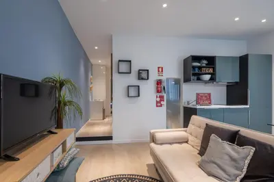 a living room with a couch and a tv at BAYLEAF Apartments - Apartamento do Tempo in Funchal