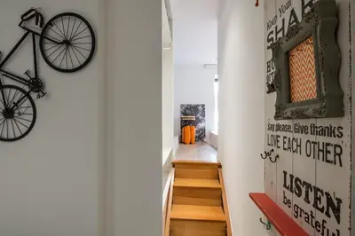 a hallway with a staircase with a bike on the wall at BAYLEAF Apartments - Apartamento do Tempo in Funchal