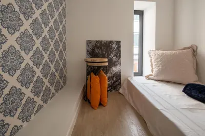 a room with a bed and a pillow and a window at BAYLEAF Apartments - Apartamento do Tempo in Funchal
