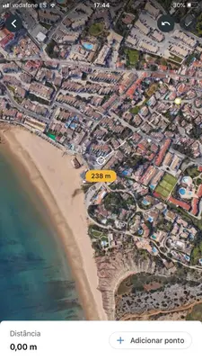 an aerial view of a beach with a yellow sign at Luz Paradise in Luz