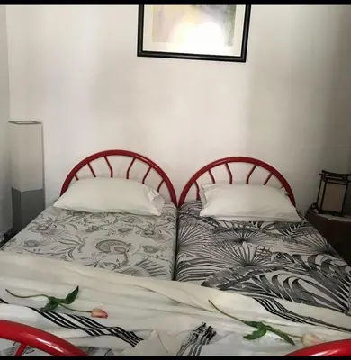 two beds sitting next to each other in a bedroom at A Casa da Avó... in São Vicente