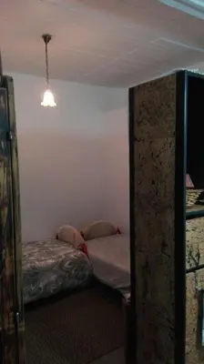a room with two beds in a room with a ceiling at A Casa da Avó... in São Vicente