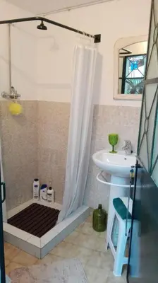 a bathroom with a shower and a sink at A Casa da Avó... in São Vicente
