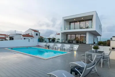 a villa with a swimming pool and a house at Biscuttela Vicentina in Praia da Arrifana