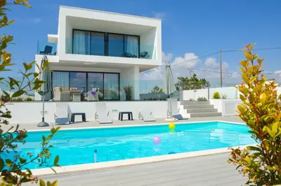 a villa with a swimming pool in front of a house at Biscuttela Vicentina in Praia da Arrifana