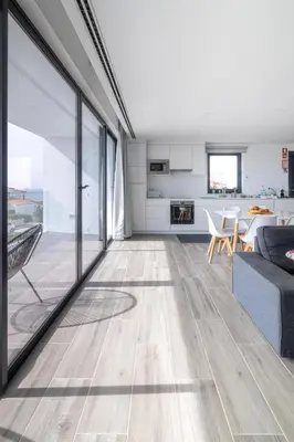 an open living room with a couch and a table at Biscuttela Vicentina in Praia da Arrifana