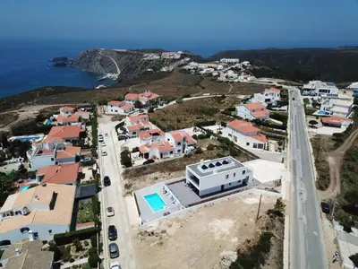 an aerial view of a town with the ocean at Biscuttela Vicentina in Praia da Arrifana
