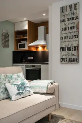 a living room with a couch and a kitchen at BAYLEAF Apartments - Casa D'Avó in Funchal