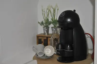 a coffee maker sitting on top of a table at BAYLEAF Apartments - Casa D'Avó in Funchal