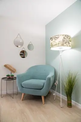 a living room with a blue chair and a lamp at BAYLEAF Apartments - Casa D'Avó in Funchal