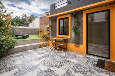 a patio with a table and chairs on a house at BAYLEAF Apartments - Casa D'Avó in Funchal