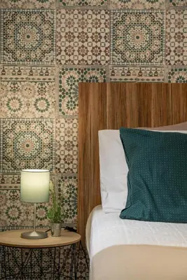 a bedroom with a bed and a table with a lamp at BAYLEAF Apartments - Casa D'Avó in Funchal
