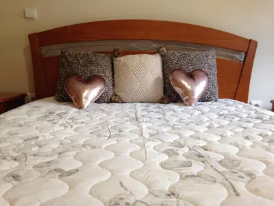 two hearts on the pillows on a bed at Bento Lodge by Madeira Holiday Rentals in Ribeira Brava