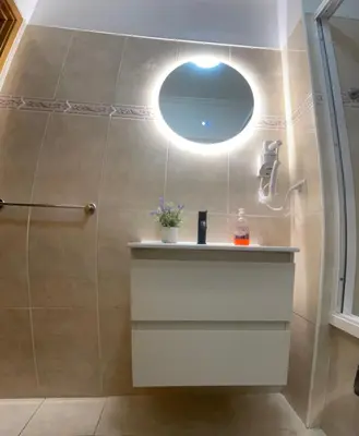 a bathroom with a shower and a sink and a mirror at Bento Lodge by Madeira Holiday Rentals in Ribeira Brava