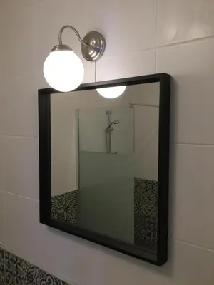 a bathroom mirror with a light and a sink at DOCEVIDA Appartement # Ocean View in Salema
