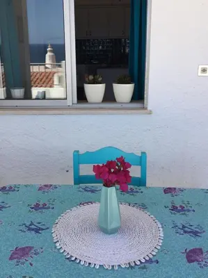 a vase with flowers in it sitting on a table at DOCEVIDA Appartement # Ocean View in Salema