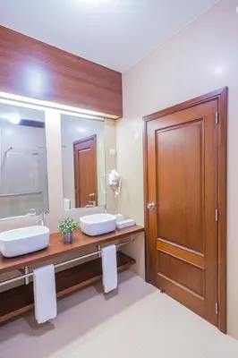 a bathroom with two sinks and a large mirror at FLH Luxury Villa Mar with Private Sea Access in Caniçal