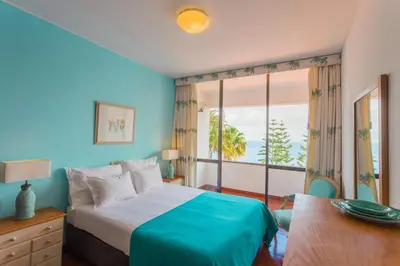 a bedroom with a bed and a large window at FLH Luxury Villa Mar with Private Sea Access in Caniçal