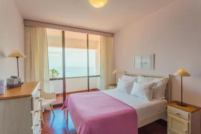 a hotel room with a bed and a large window at FLH Luxury Villa Mar with Private Sea Access in Caniçal