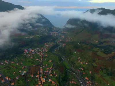 an aerial view of a city in the mountains with clouds at Pereira Place in São Vicente