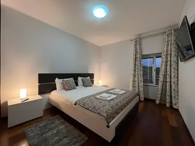 a bedroom with a large bed and a window at Villas Quinta da Lapa by AnaLodges in Câmara de Lobos