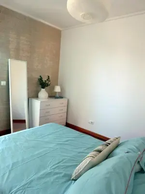 a bedroom with a bed with a pillow on it at Marias sea cottage in Funchal