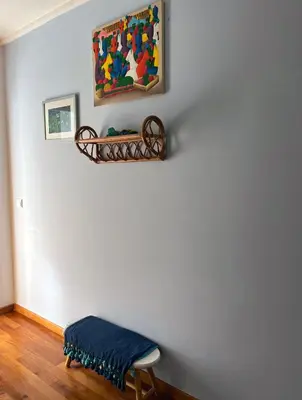 a room with a blue blanket on a wall and a stool at Marias sea cottage in Funchal