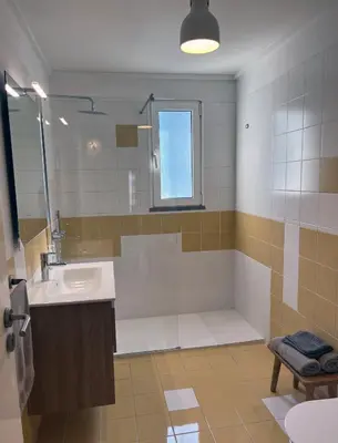a bathroom with a sink and a shower at Marias sea cottage in Funchal