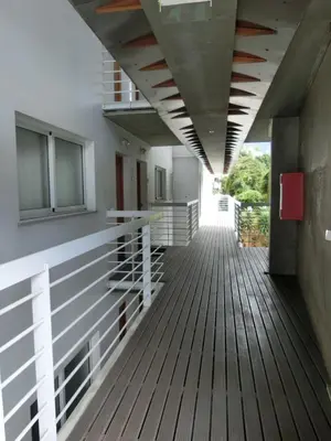 a hallway of a building with a wooden deck at Marias sea cottage in Funchal
