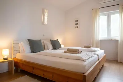 a bedroom with a large bed with white sheets at Marécasa in Aljezur