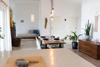 a living room with a table with wine glasses on it at Marécasa in Aljezur
