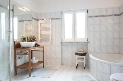 a bathroom with a tub and a sink at Marécasa in Aljezur