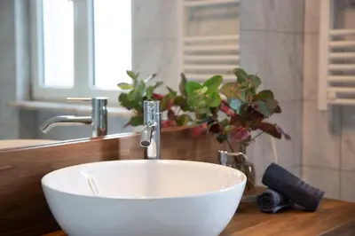 a white sink in a bathroom with a mirror at Marécasa in Aljezur