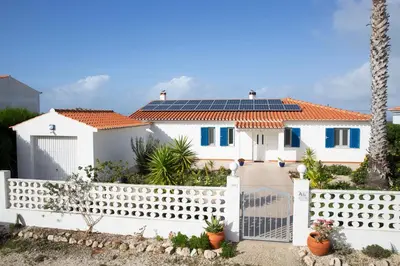 a white house with solar panels on its roof at Marécasa in Aljezur