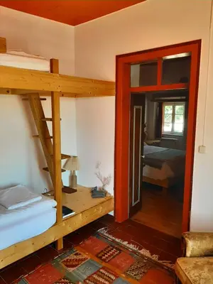 a room with two bunk beds and a bedroom at Salmoura in Vila do Bispo