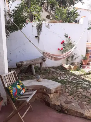 a hammock and a bench in a yard at Salmoura in Vila do Bispo