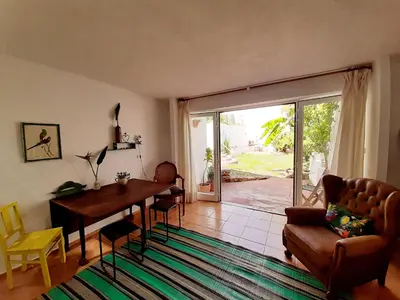 a living room with a table and a couch at Salmoura in Vila do Bispo