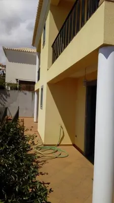 a building with a hose laying on a courtyard at Sea View House in Ribeira Brava